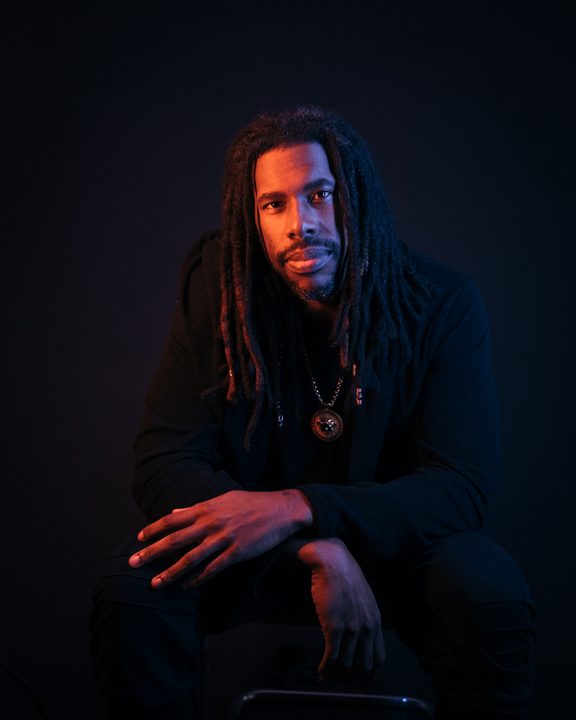 Flying Lotus poses for a headshot.