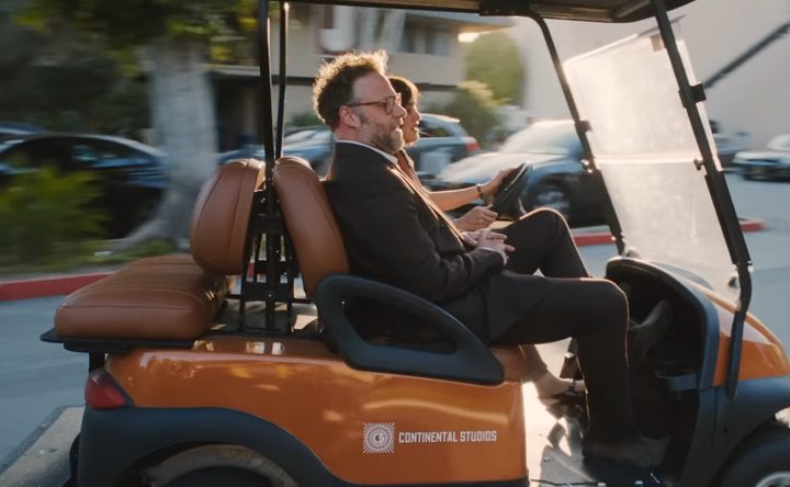 Matt and Quinn riding in a cart in "The Studio."