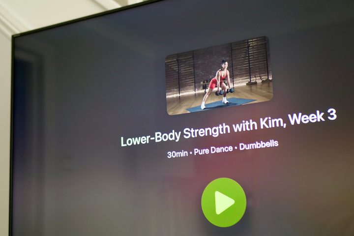 An Apple Fitness+ workout screen on a TV.