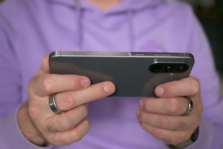 A person holding the Samsung Galaxy A56.