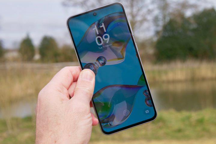 A person holding the Samsung Galaxy A56.