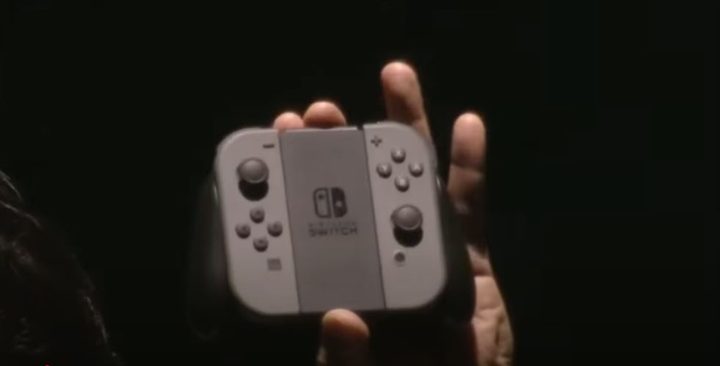 A hand holds a Joy-con in its grips.