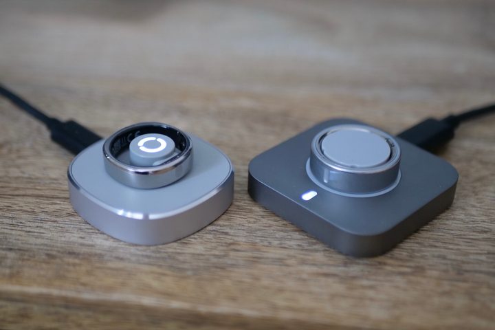 The RingConn Gen 2 Air and the Oura Ring 4 on charging plinths.