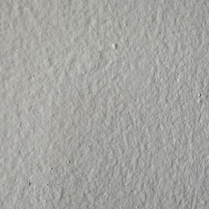 A closeup of the texture on a painted section of drywall.