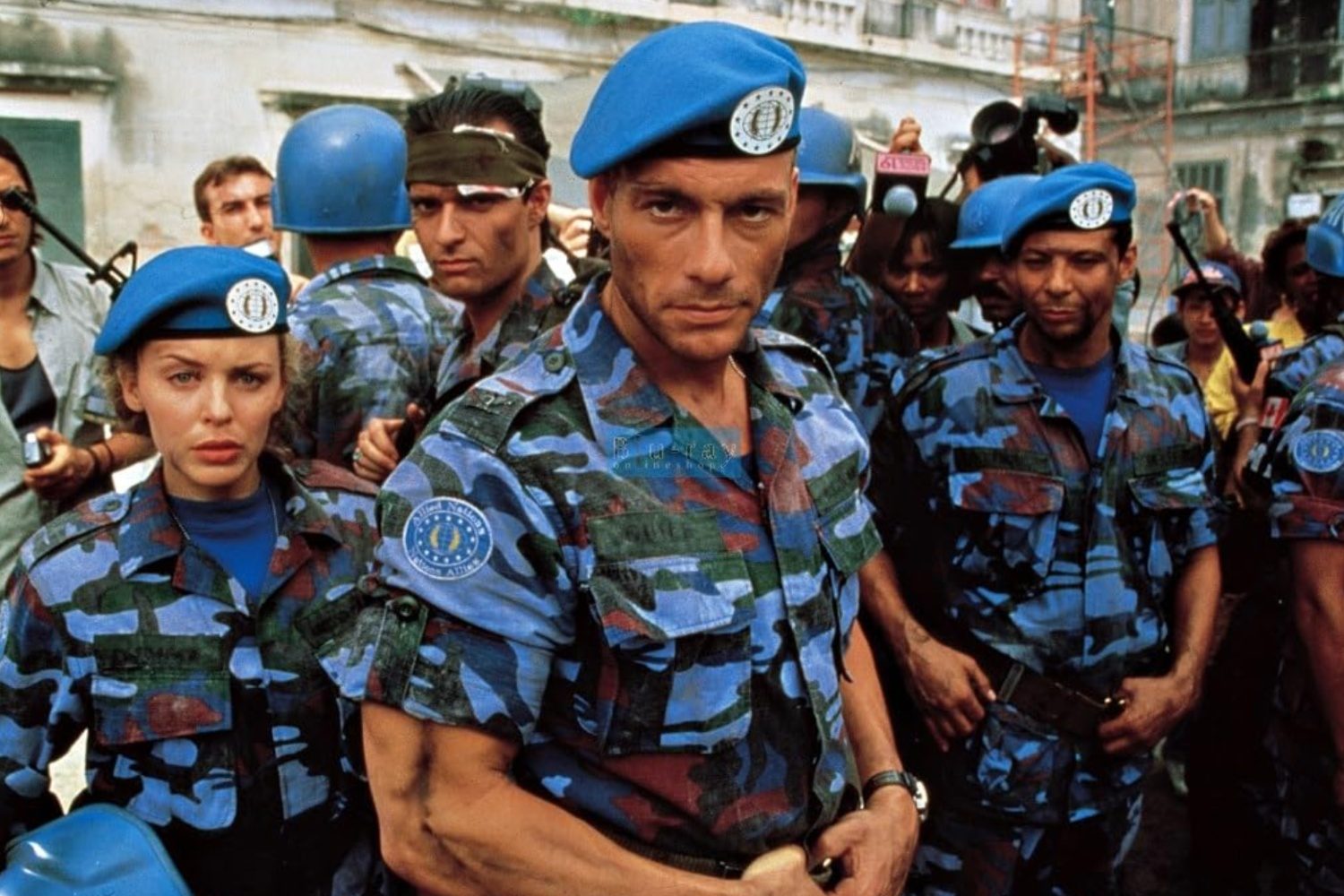 A group of soldiers stand in front of the camera.