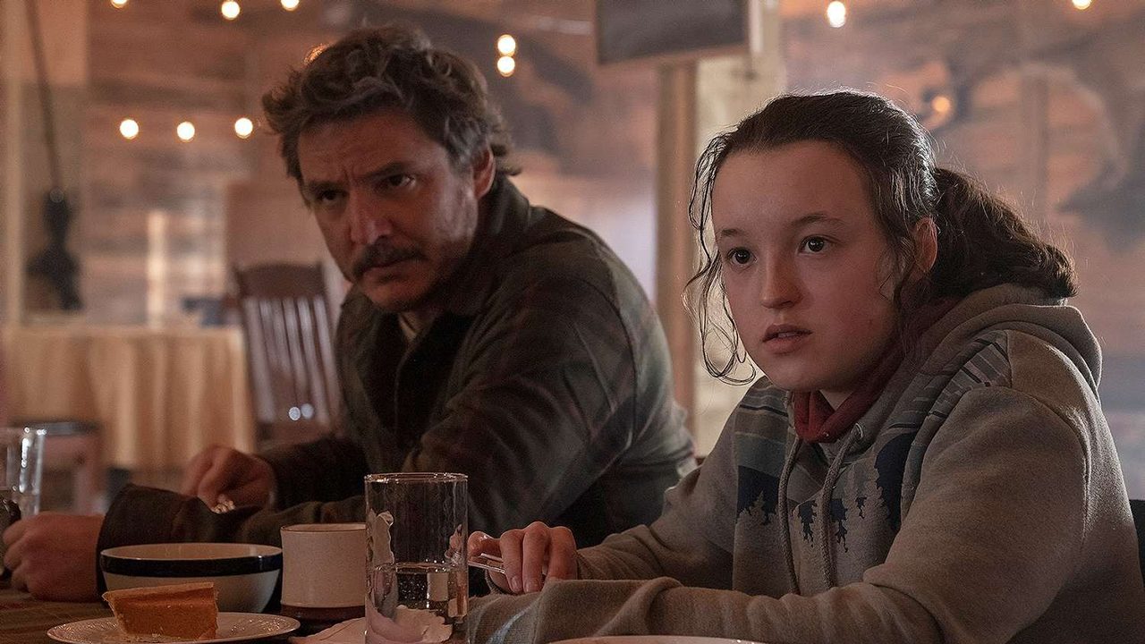 Joel and Ellie sitting together at a bar in The Last of Us season 2.
