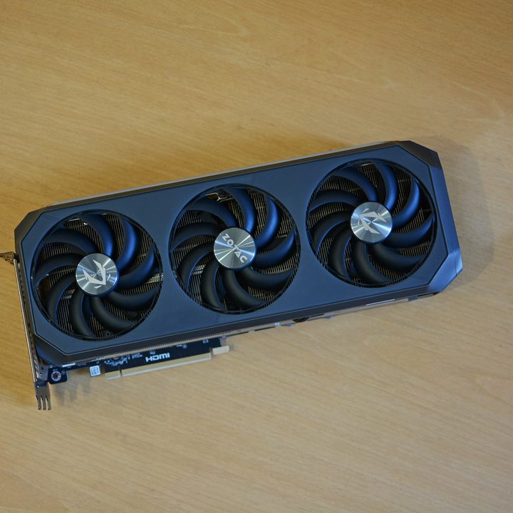 The Zotac RTX 5070 Ti Amp Extreme Infinity graphics card placed on a wooden surface