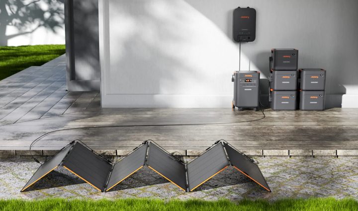 Jackery power station with solar panels in a backyard
