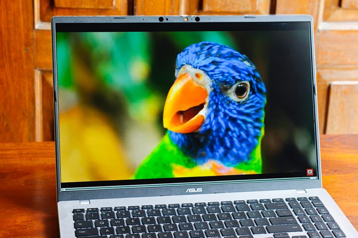 16-inch IPS-level display on the Asus Vivobook 16 X1607QA Copilot+ PC laptop with Qualcomm Snapdragon X ARM 64 chip on a wooden surface.