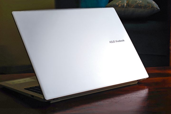 Backplate of the silver Asus Vivobook 16 X1607QA Copilot+ PC laptop with Qualcomm Snapdragon X ARM 64 chip on a wooden surface.