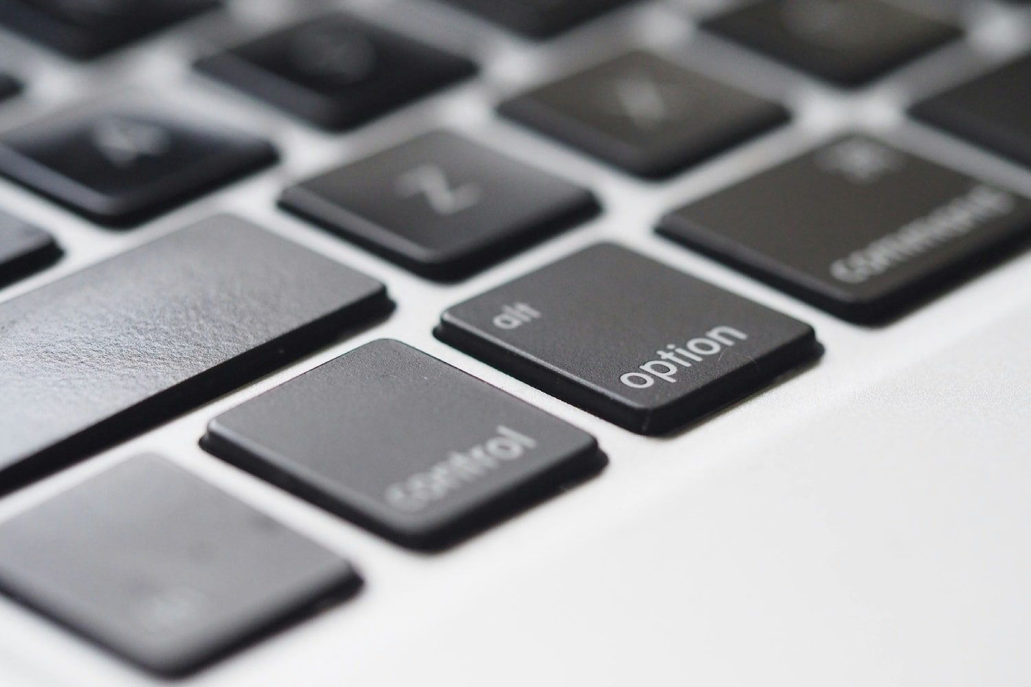A close-up of a MacBook keyboard, showing the keycaps in detail.
