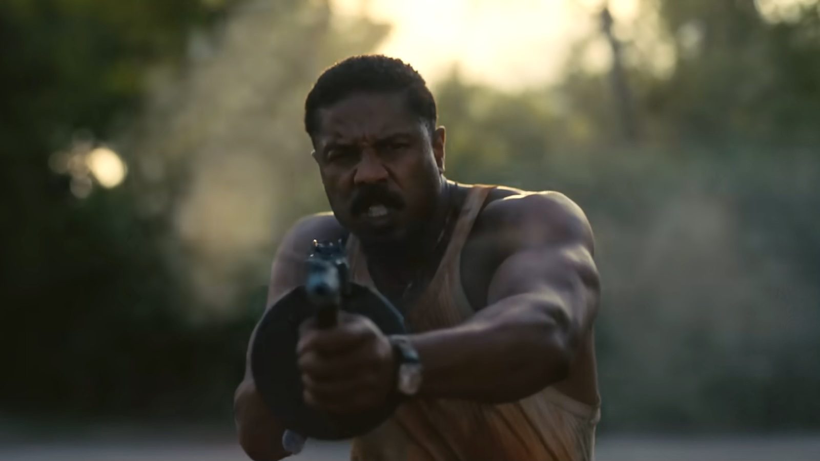 Michael B. Jordan firing a gun in "Sinners."