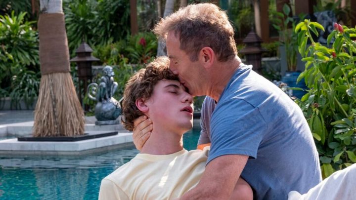 Timothy Ratliff holding his unconscious son Lochlan in The White Lotus.