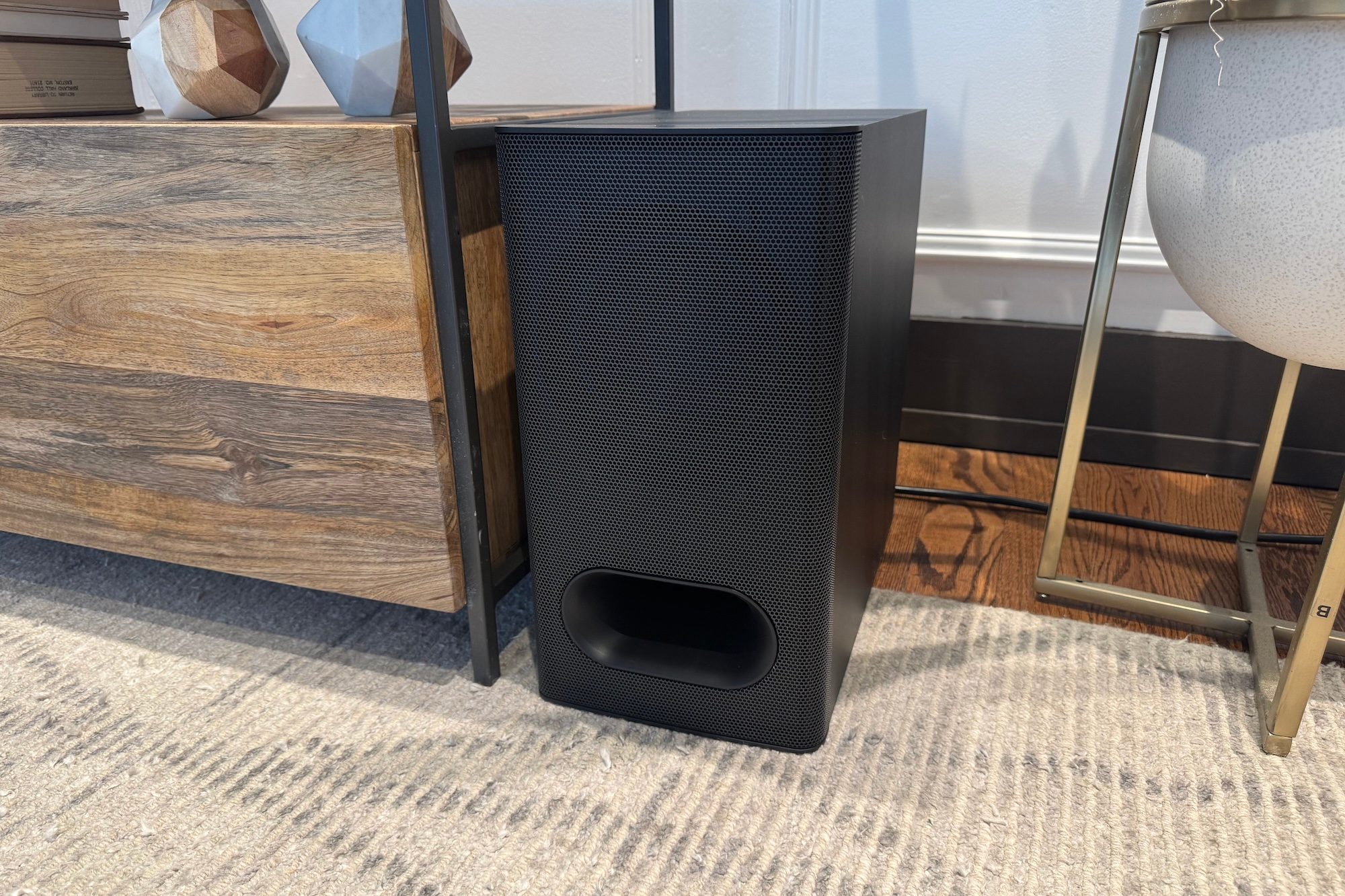The subwoofer that comes with the Sony Bravia Theater Bar 6 next to a wooden table.