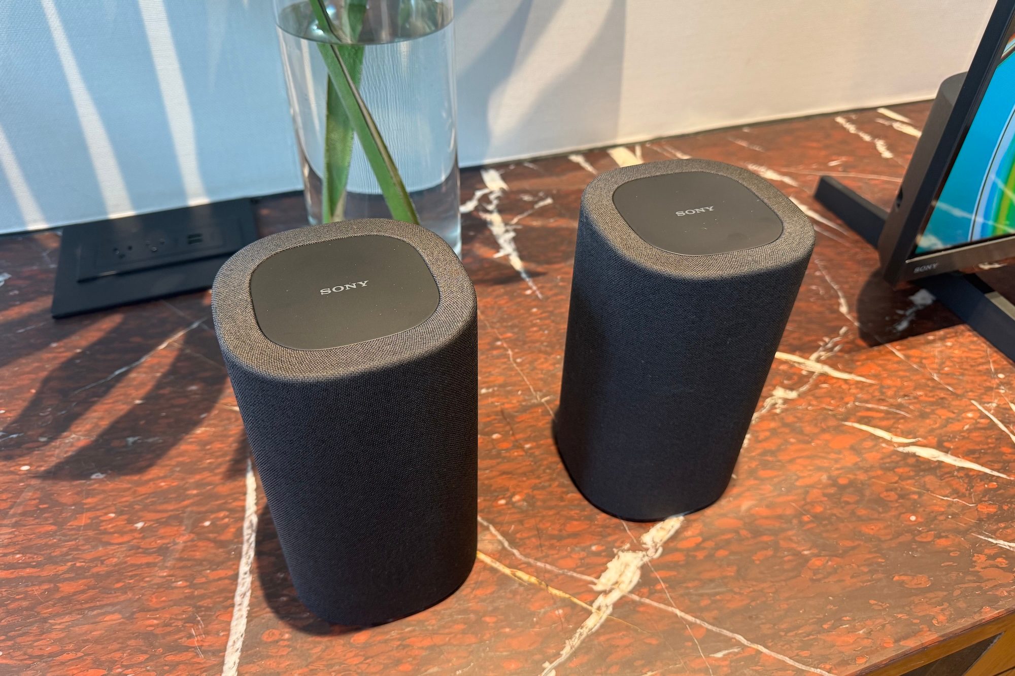 The Sony Bravia Theater Rear 8 speakers on a marble table.