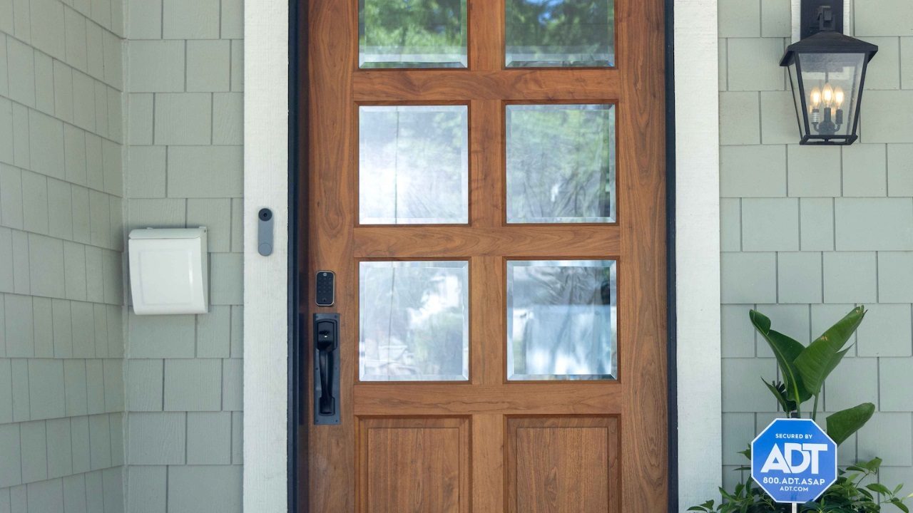 A door with the Yale Assure Lock 2 Touch installed and ADT sign nearby.