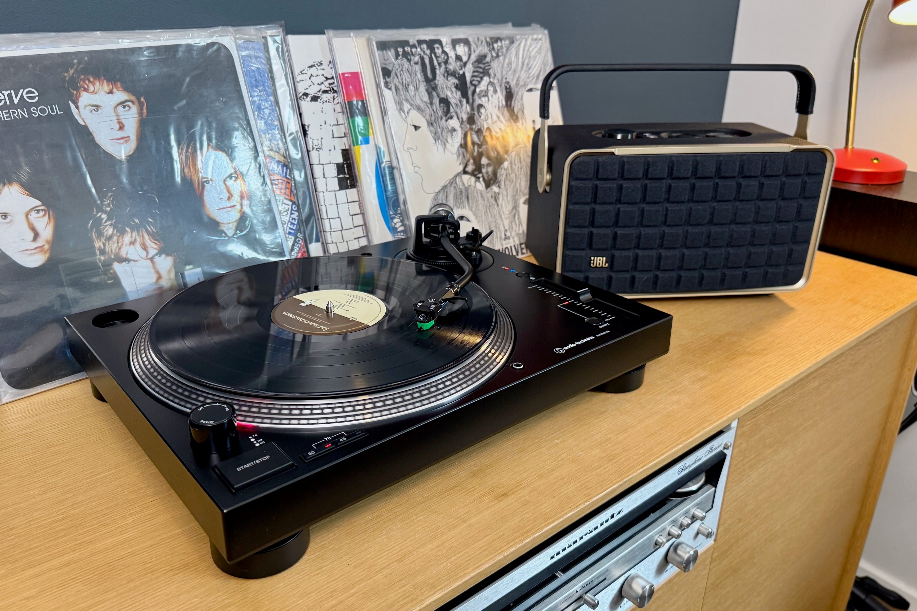 The Audio-Technica AT-LP120XBT-USB Bluetooth turntable with a JBL Authentics 300 Bluetooth speaker.