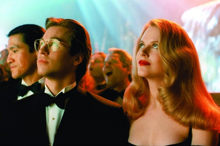 A man and woman look up and stare.