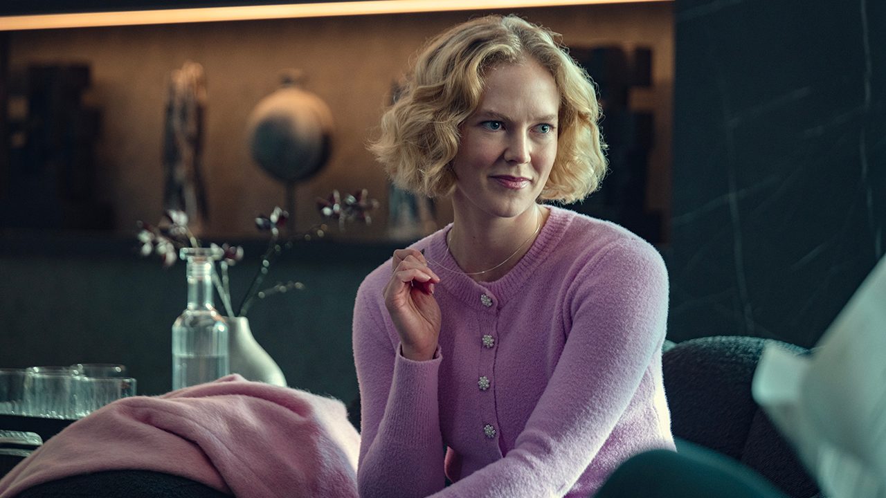 Verity sitting in the office looking smug in the Black Mirror episode Bete Noire.