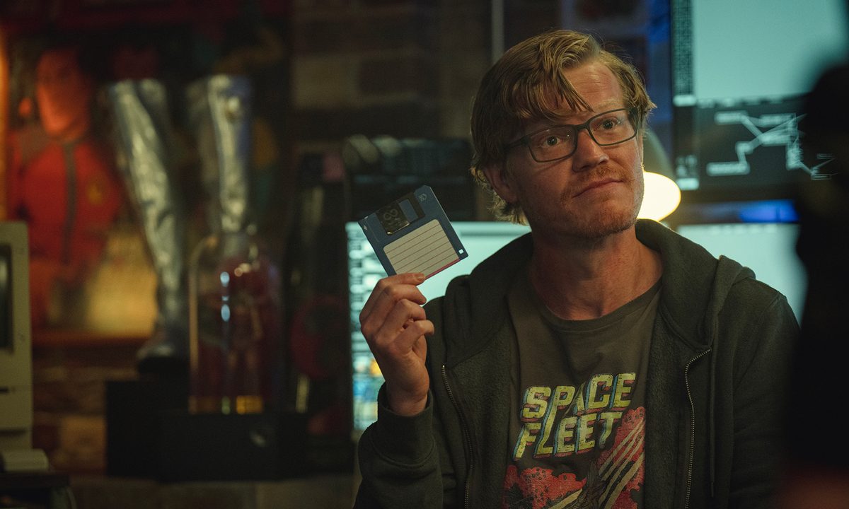Robert Daly holding up a blue floppy disk in Black Mirror