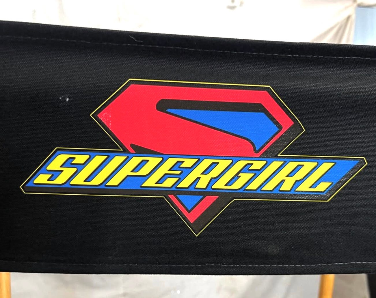 Supergirl logo platered on a chair.