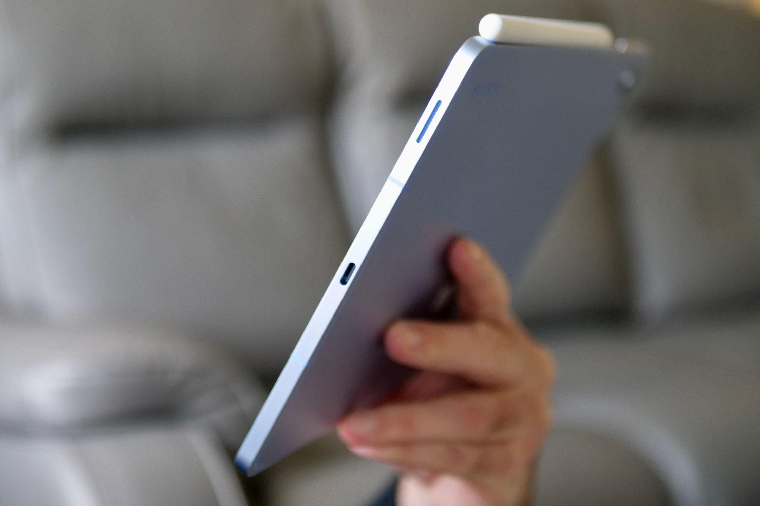 A person holding the Samsung Galaxy Tab S10 FE.