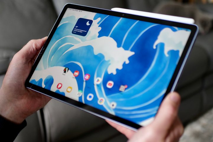 A person holding the Samsung Galaxy Tab S10 FE.