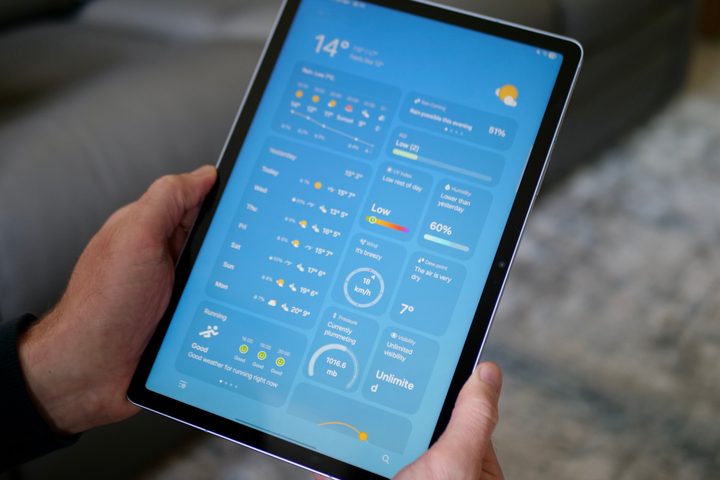 A person holding the Samsung Galaxy Tab S10 FE.