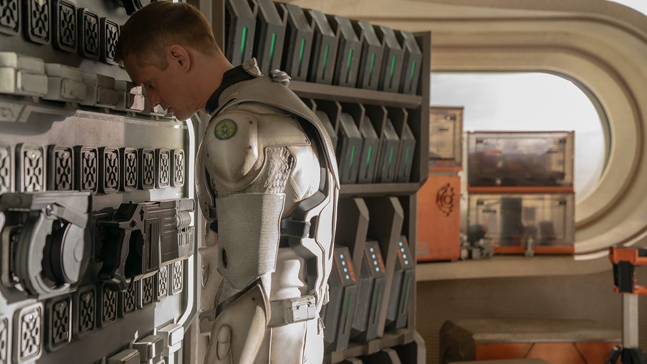 Alexander Skarsgard with his head against machines in Murderbot.