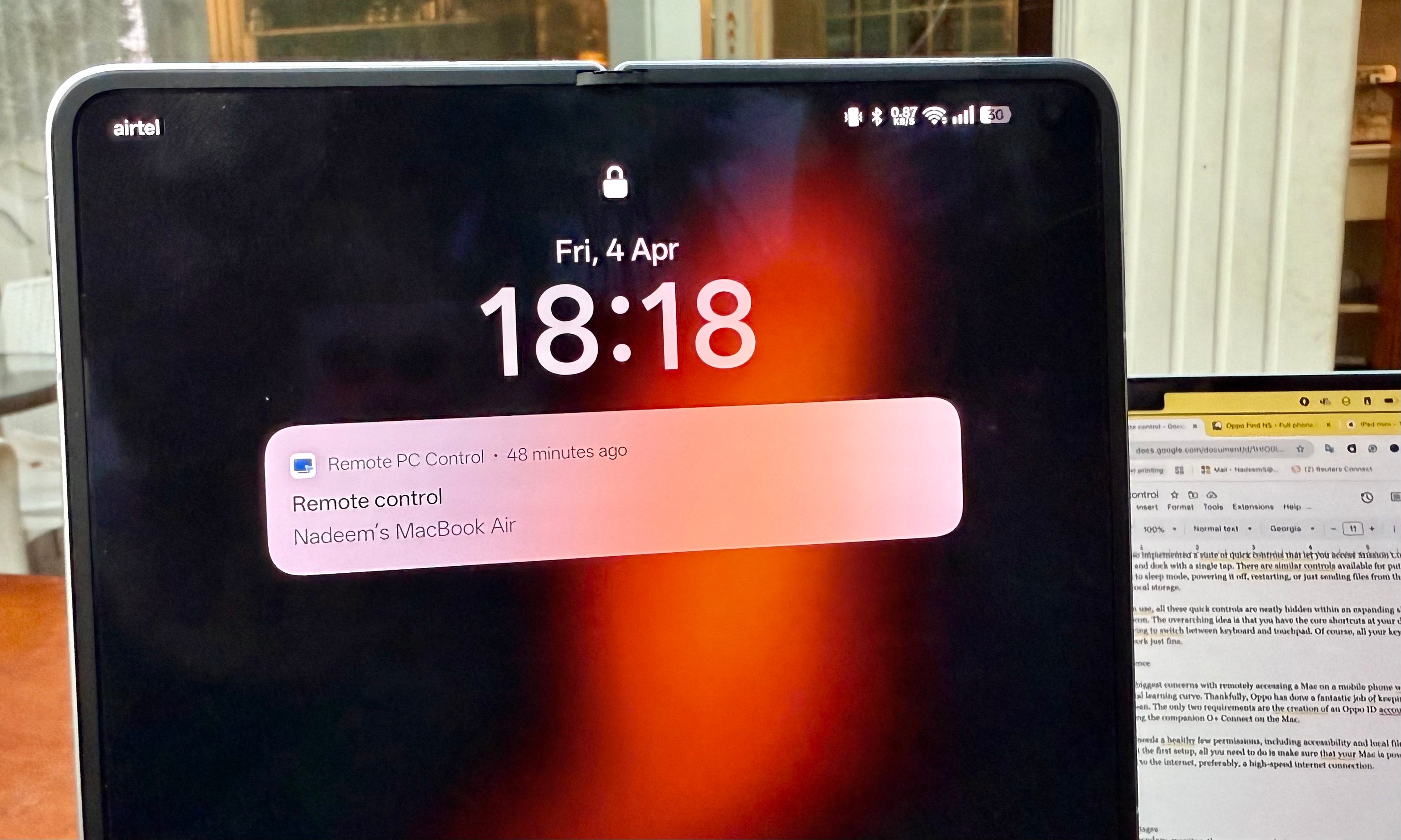 A person remotely accessing a Mac using the Oppo Find N5.