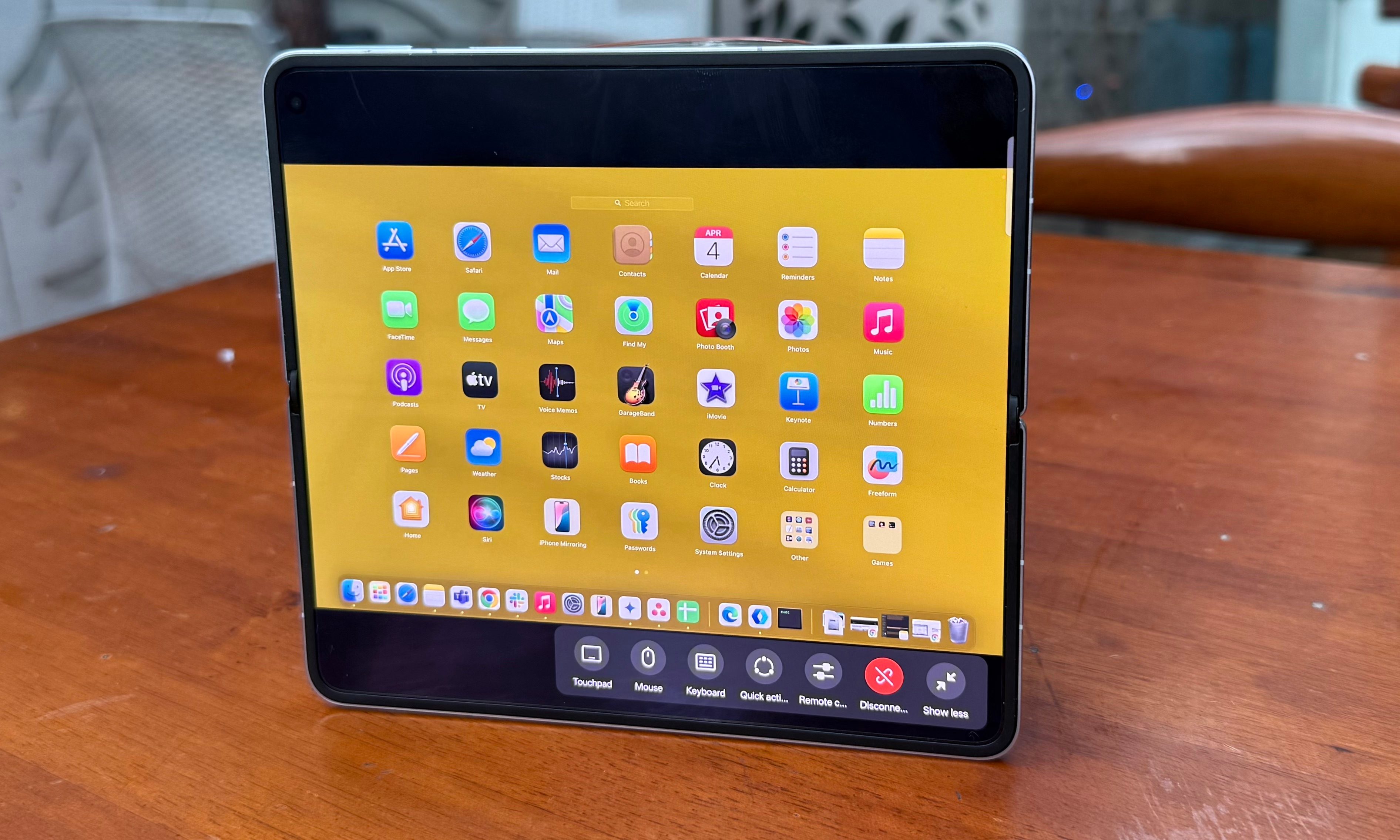 A person is using their Oppo Find N5 to remotely access a Mac.