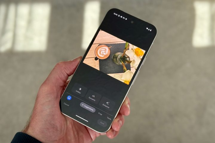 A person using the Google Photos app on the Pixel 9a.
