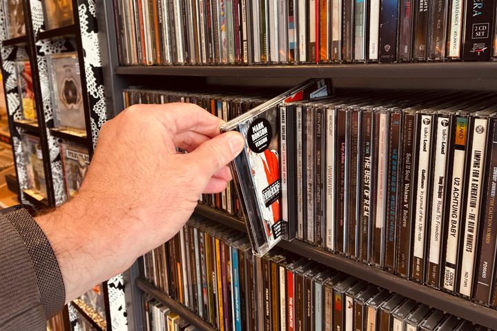 Choosing a CD in Spin Sounds record store in the U.K..
