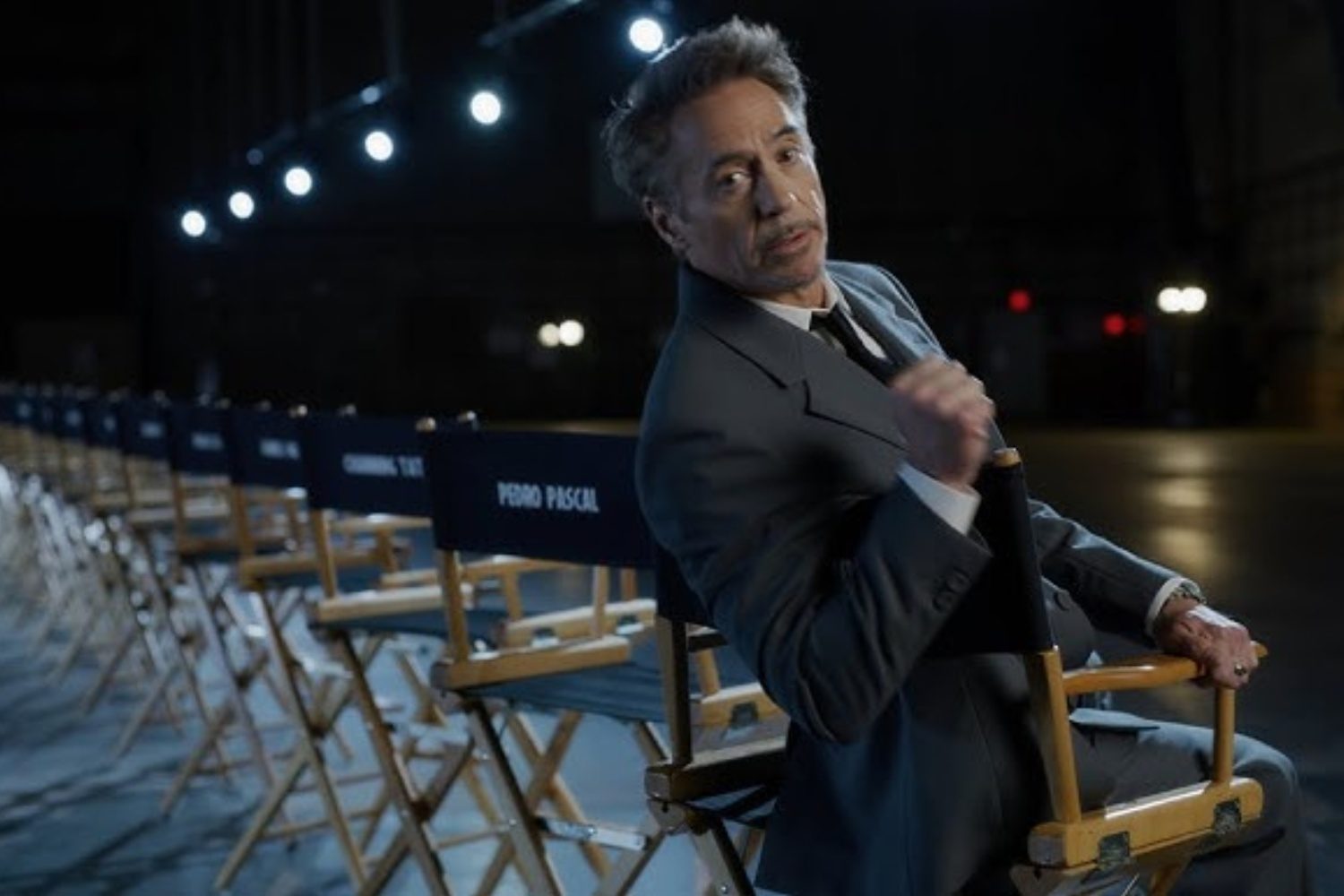 Robert Downey Jr. sits in a chair and stares on the set of Avengers: Doomsday.