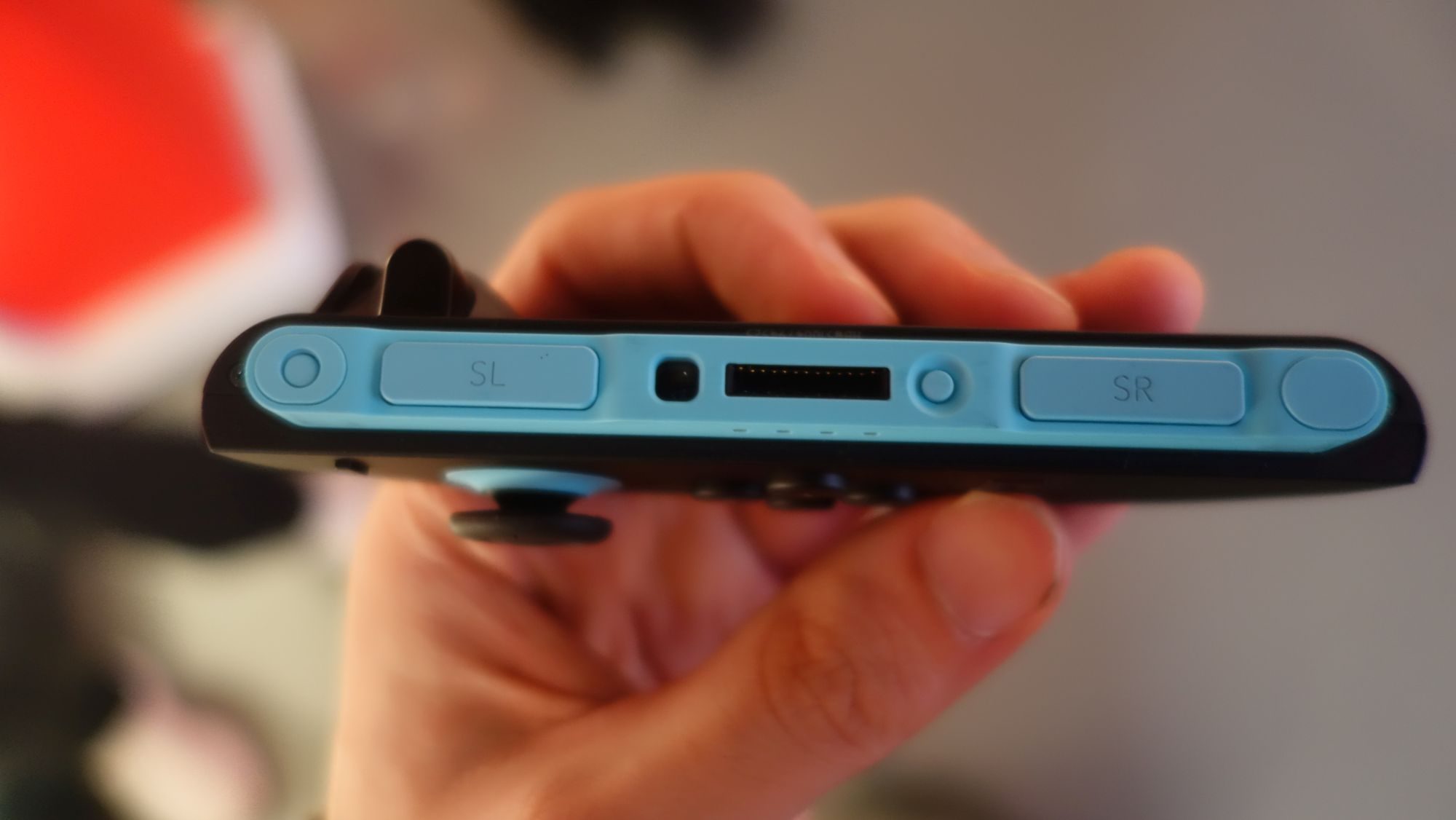 A hand holds a Switch 2 Joy-con.