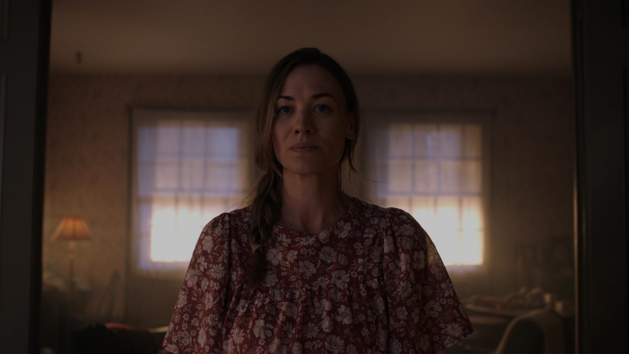 Serena standing in a doorway wearing a nightgown in The Handmaid's Tale.