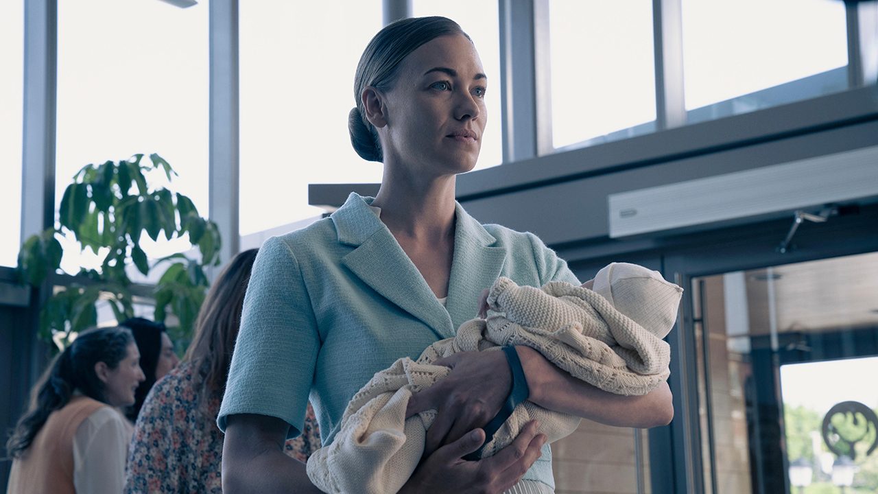 Serena standing with baby Noah in The Handmaid's Tale.