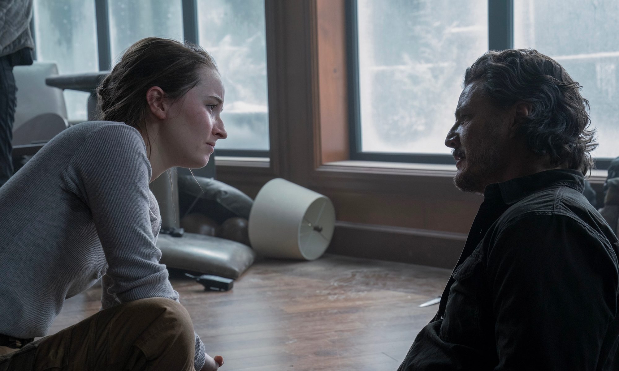 Abby crouched down beside Joel in The Last of Us.