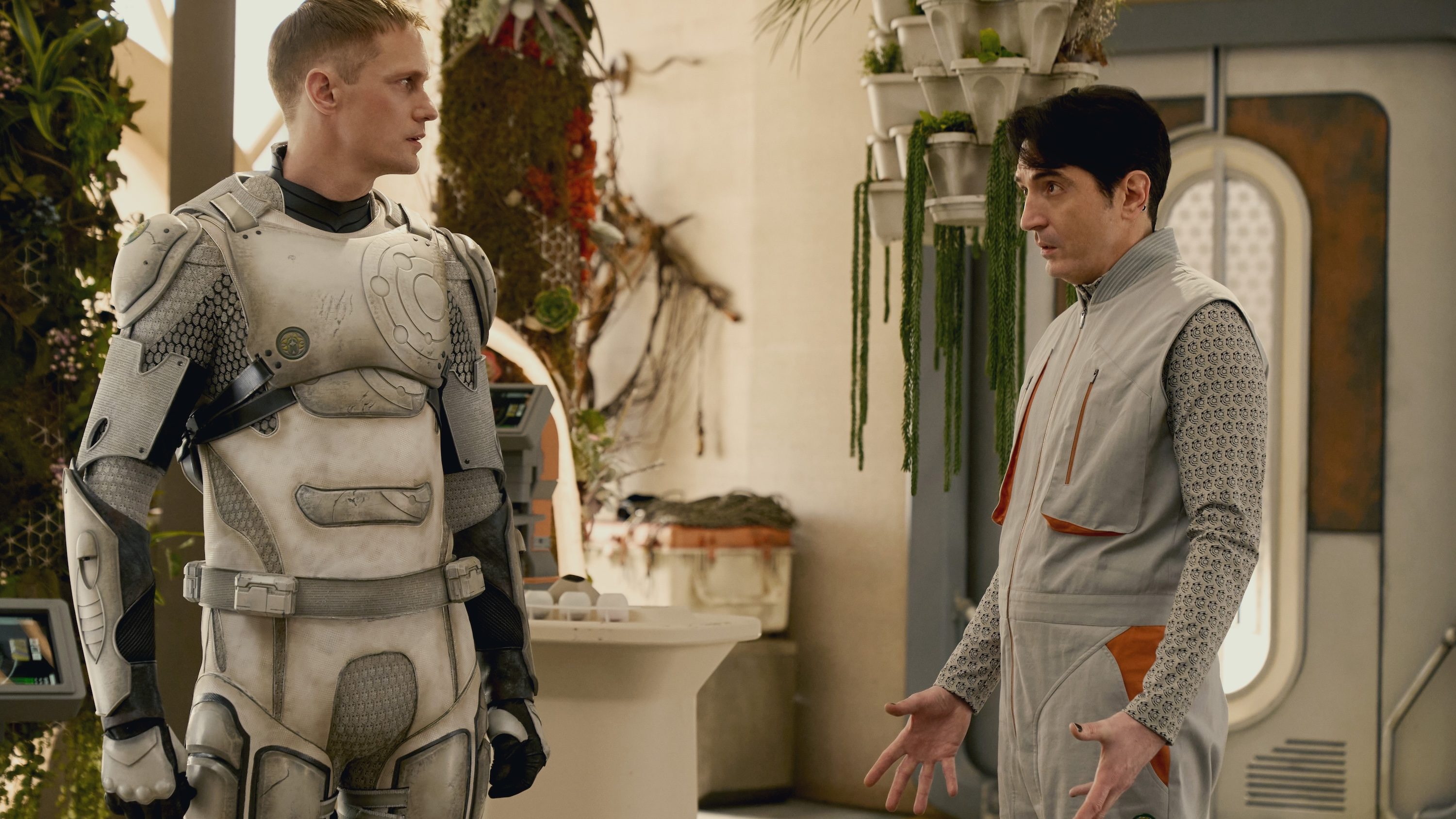 A robot and a man stare at each other in Murderbot.