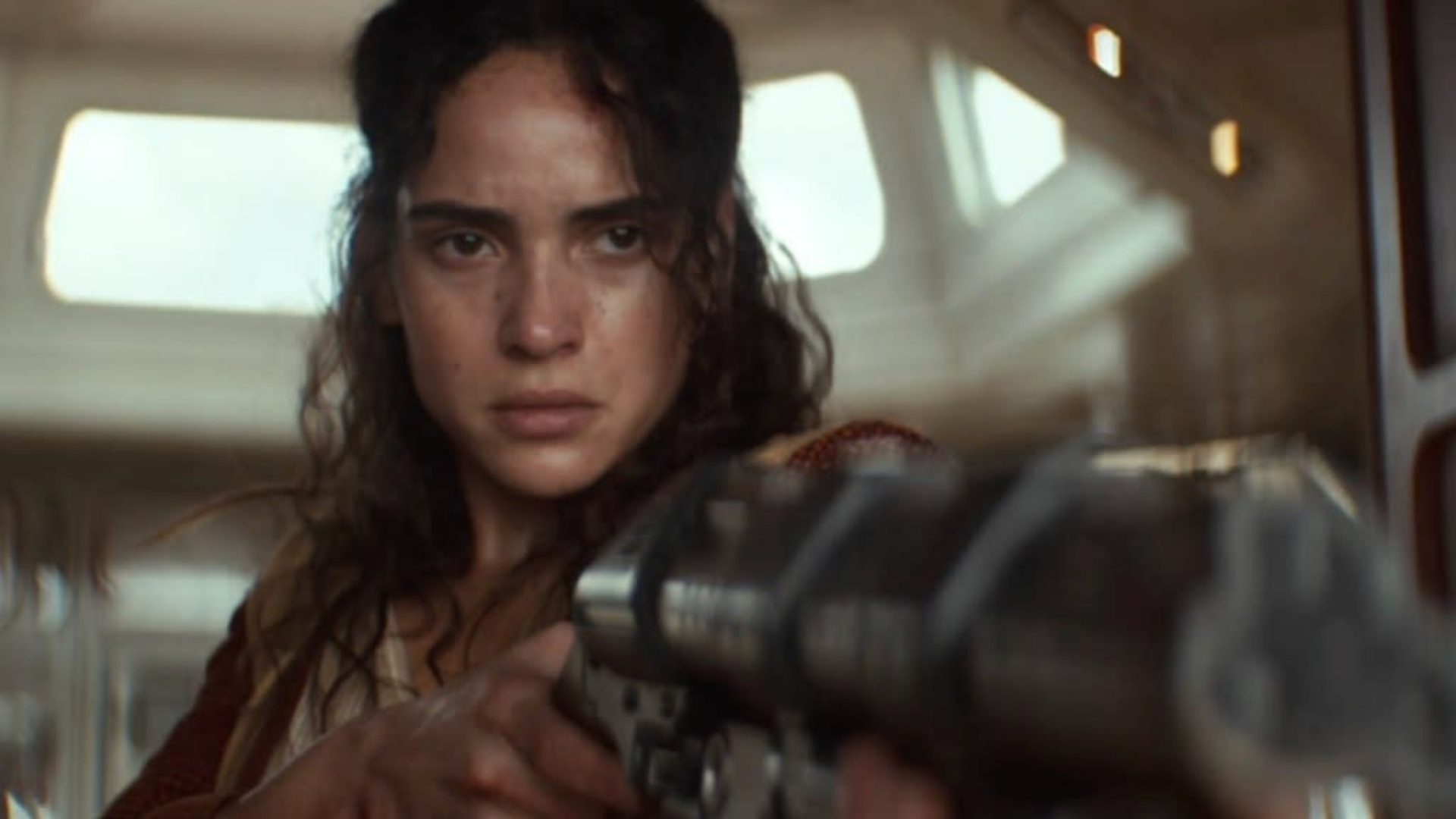 Bix Caleen with a pained expression aiming a gun in Andor season 2.
