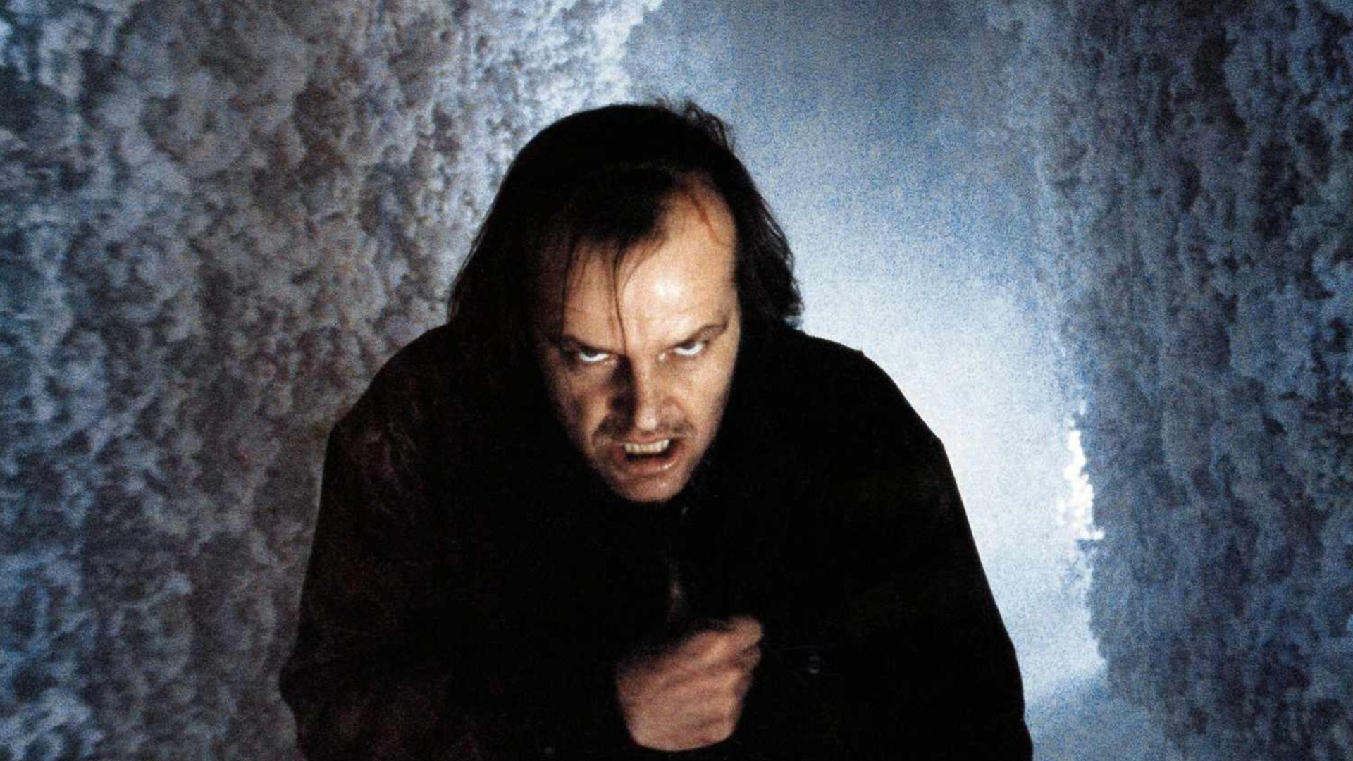 Jack Nicholson as Jack Torrance gritting his teeth and giving a menacing stare in "The Shining."