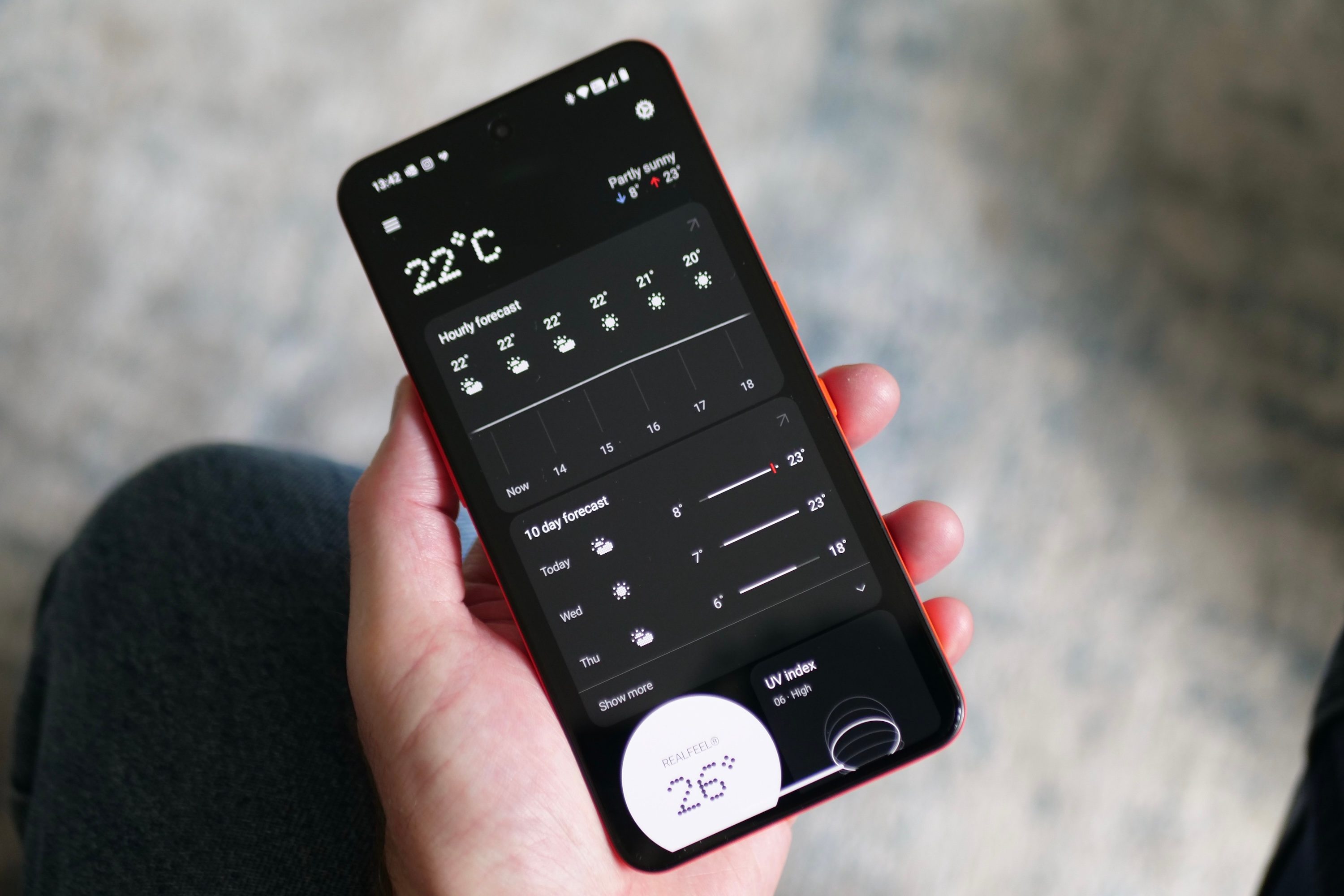 A person holding the CMF Phone 2 Pro showing the weather app.