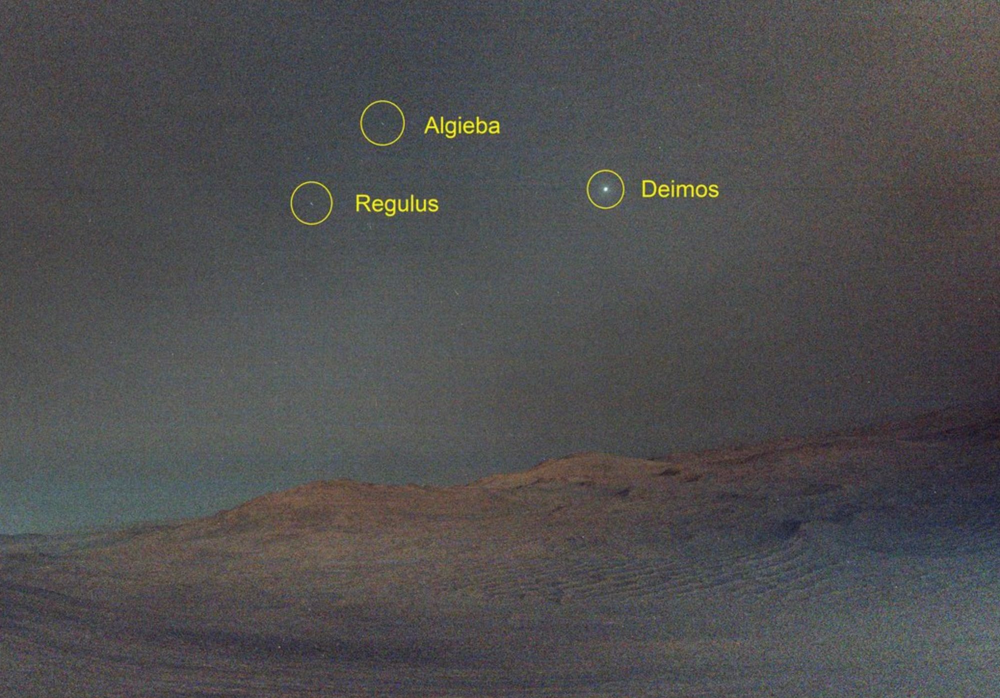 Deimos above the surface of Mars.