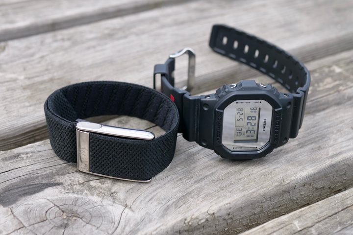 The Whoop 5.0 with a watch for size comparison.