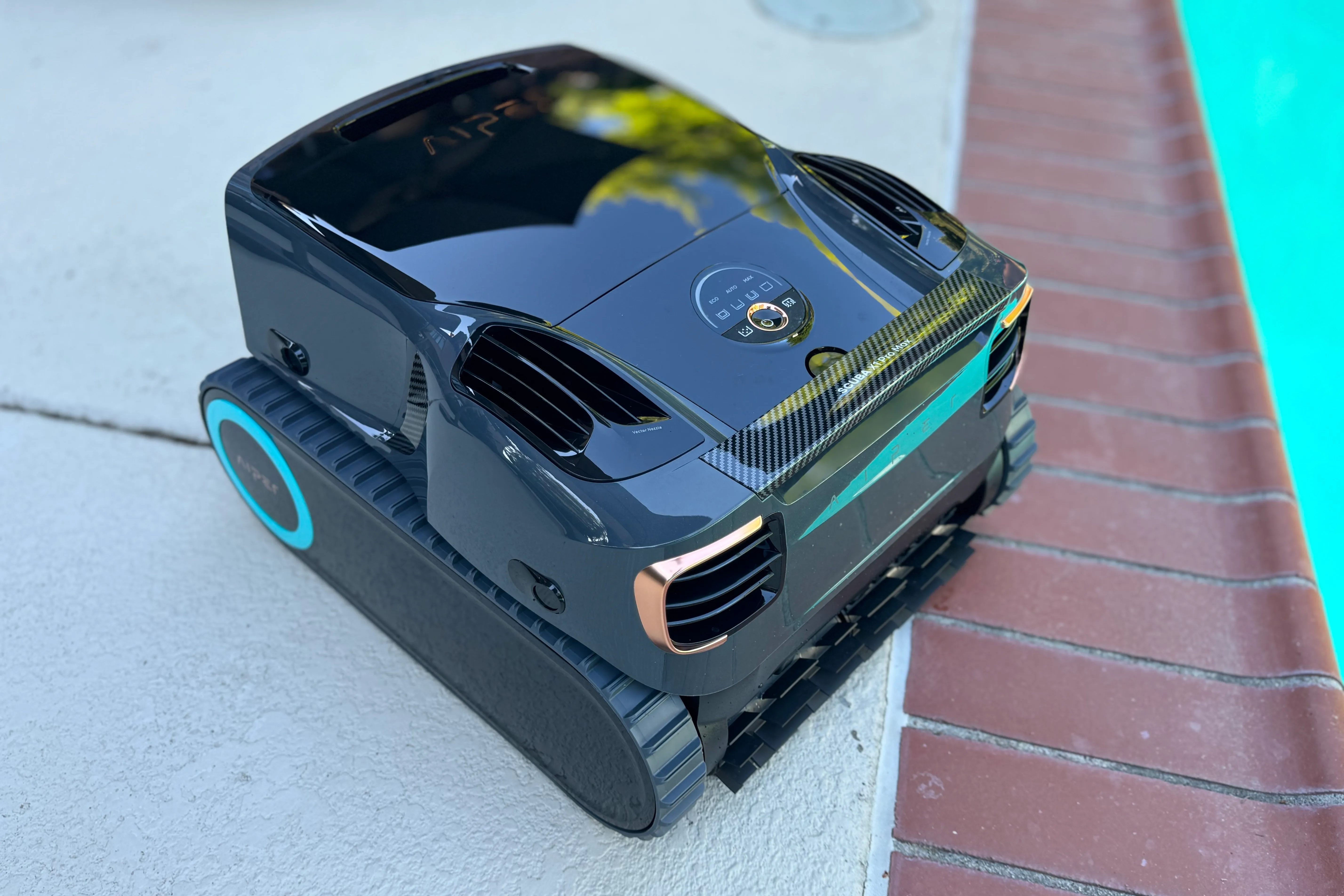 Aiper Scuba X1 Pro Max pool cleaner sitting beside a pool