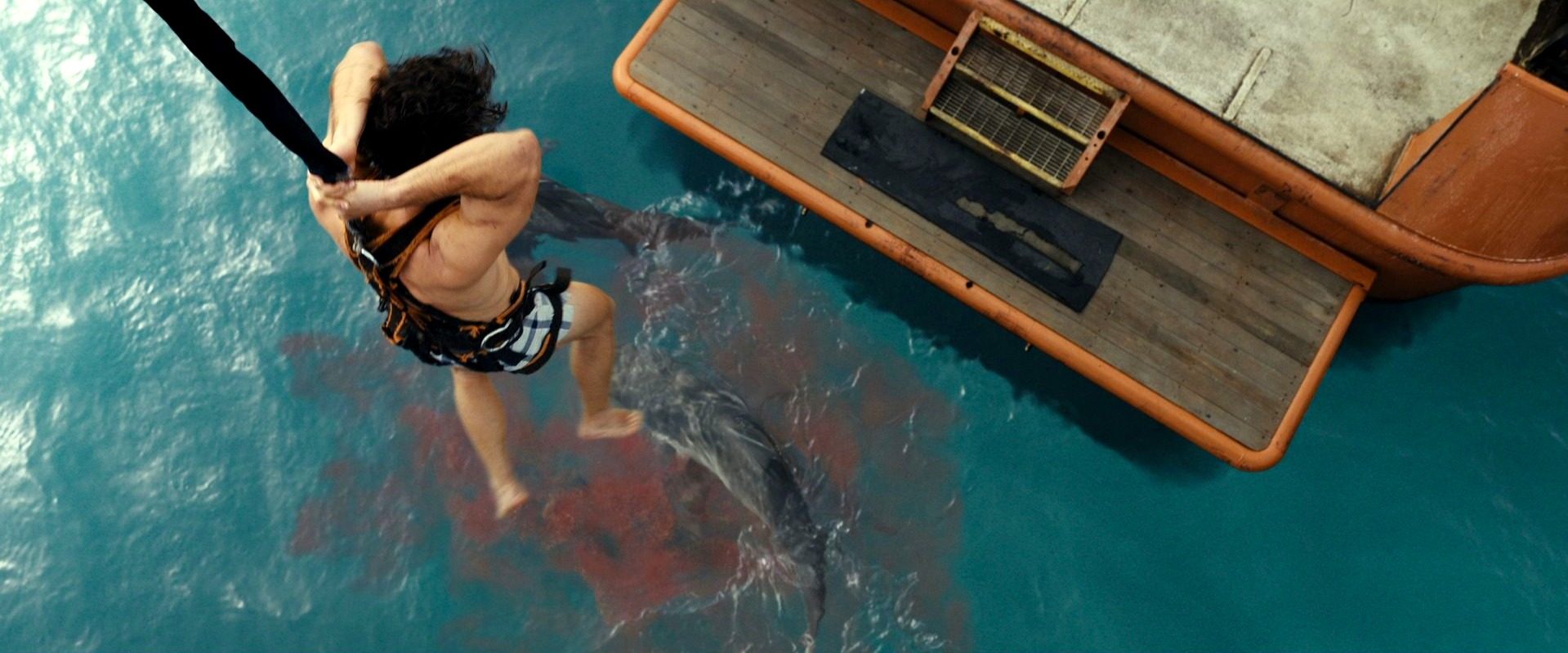 A boy hangs over the water in Dangerous Animals.