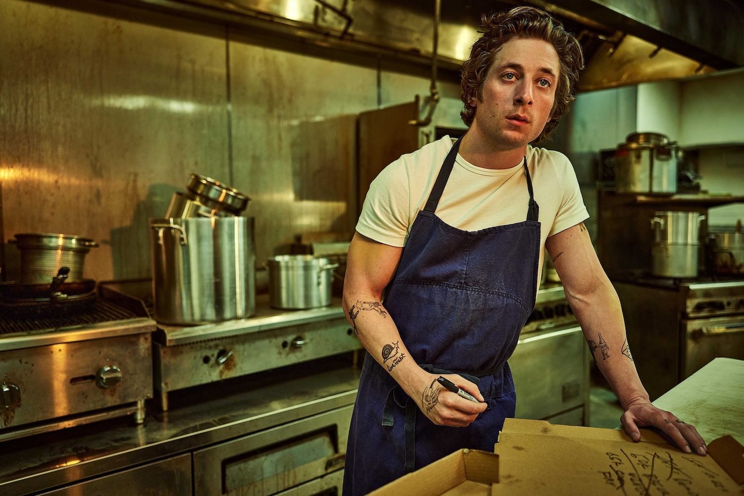 Jeremy Allen White leans in the kitchen in The Bear.