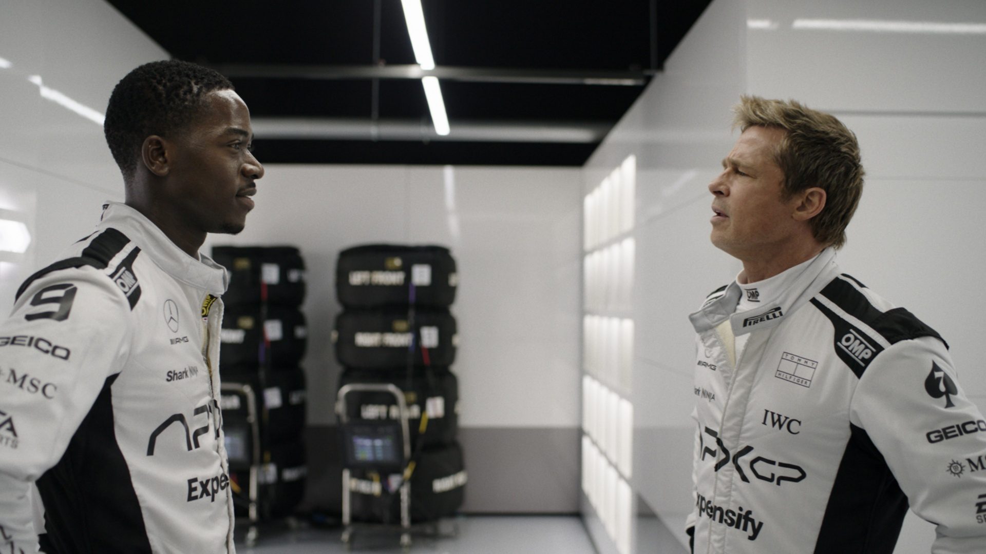 Damson Idris and Brad Pitt staring at each other in "F1."