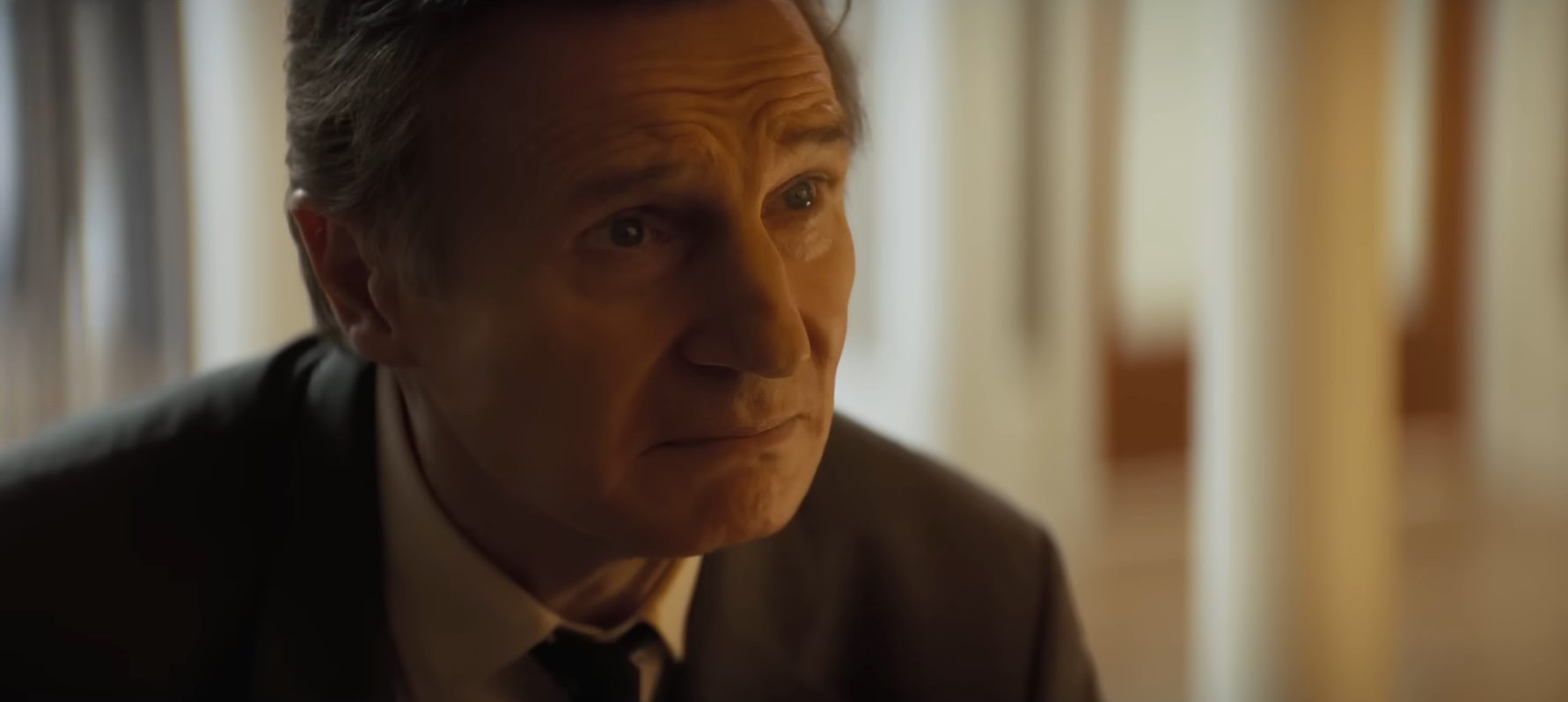 A closeup of Liam Neeson as Frank Drebin Jr. in The Naked Gun.