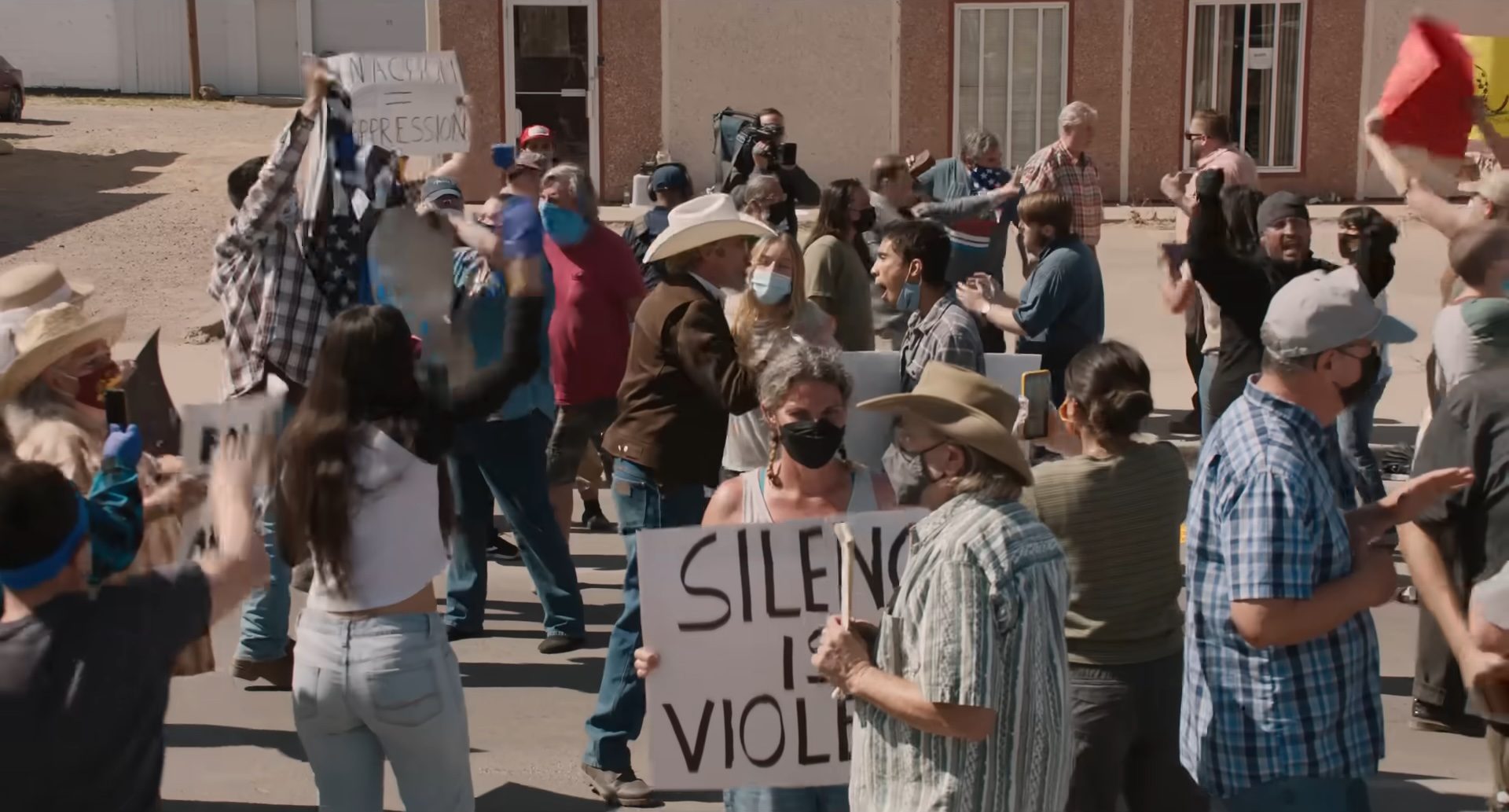 A crowd of people shouting at a demonstration in Eddington.